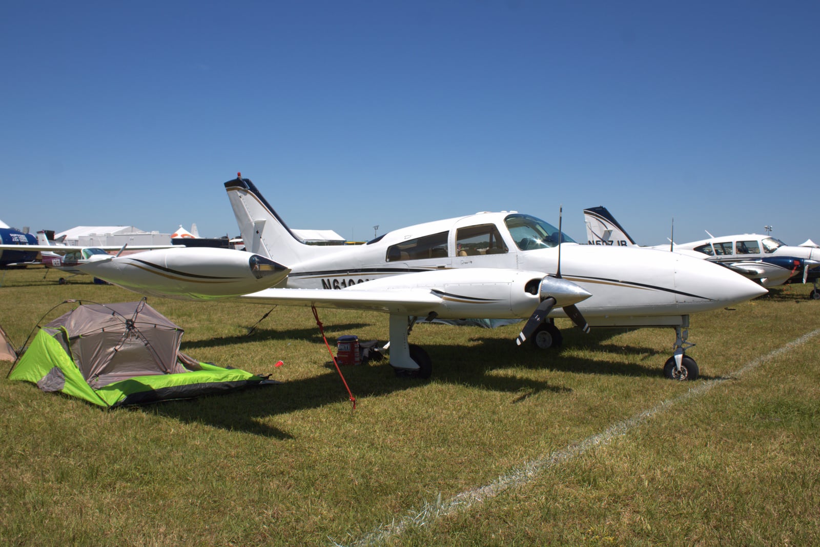 Cessna 310R in flight, showing the tip tanks